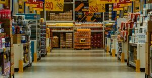 Corredor de supermercado com produtos expostos, representando o impacto do congelamento de preços dos alimentos no varejo.