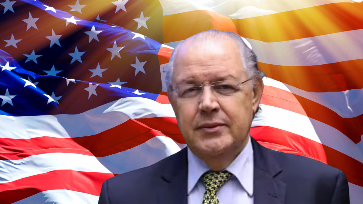 Luiz Carlos Hauly nos EUA discutindo oportunidades de negócios no Brasil, com bandeira americana ao fundo.