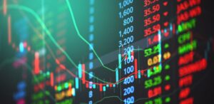 A imagem mostra gráficos da bolsa de valores para representar o mercado financeiro.