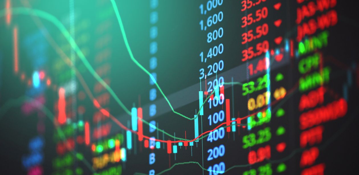 A imagem mostra gráficos da bolsa de valores para representar o mercado financeiro.