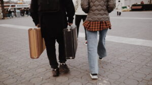Pessoas com malas caminhando em direção ao embarque, ilustrando a responsabilidade da agência de turismo na orientação ao cliente.
