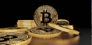 A imagem mostra moedas de Bitcoin.