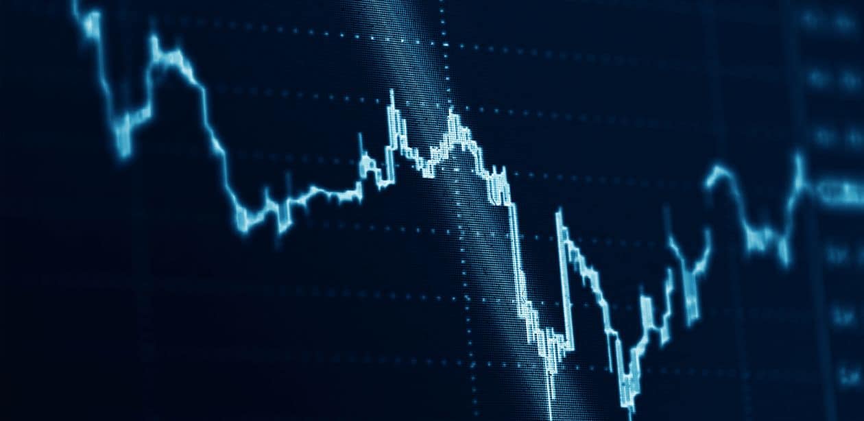 A imagem mostra um gráfico oscilando para representar as ações da Wall Street.