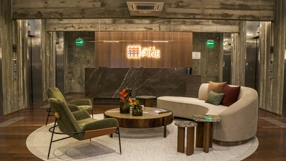 Recepção do Banco Pine com logotipo iluminado, representando o lucro do Banco Pine no 1T25, que alcançou R$ 73,5 milhões